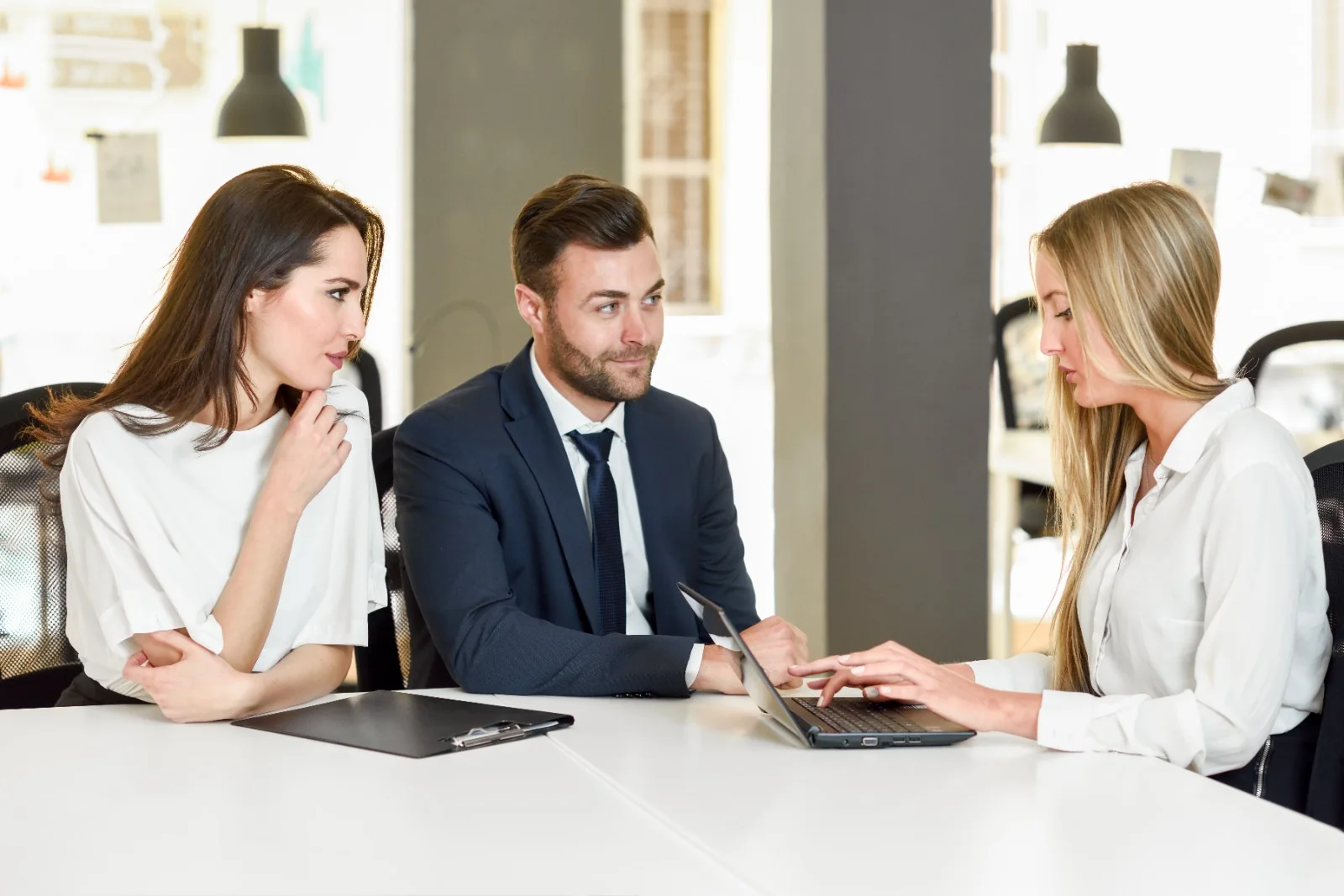 A Biznexa adviser taking two founders through their sponsorship agreement on a laptop